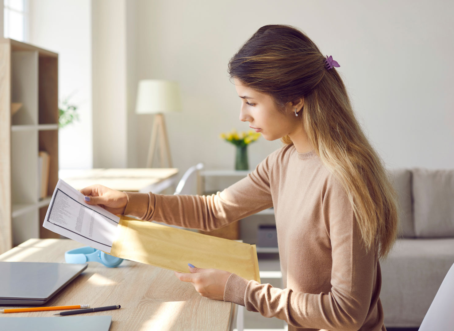 A college student receives personalized mail from their university.